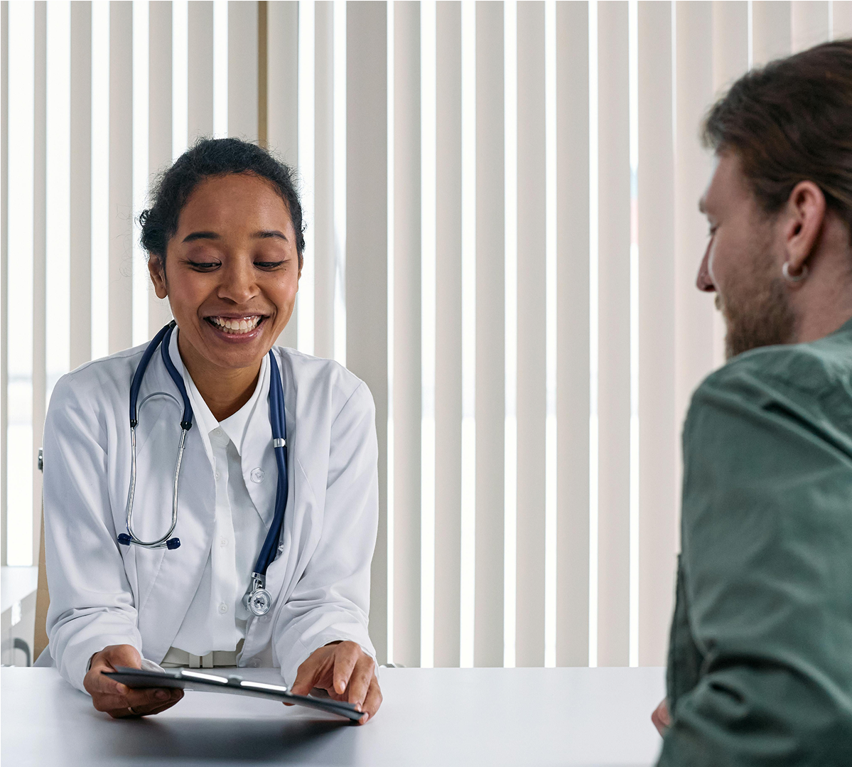Doctor discussing results with a patient on a tablet